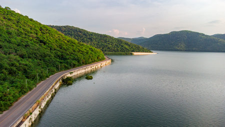 Muak Lek reservoir in Saraburi from aerial bird eye view. Beautiful unseen nature at Muak Lek dam with roadway beside with water and tree hill.の写真素材