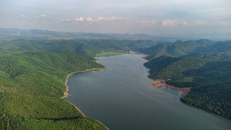 Muak Lek reservoir in Saraburi from aerial bird eye view. Beautiful unseen nature at Muak Lek dam with roadway beside with water and tree hill.の写真素材