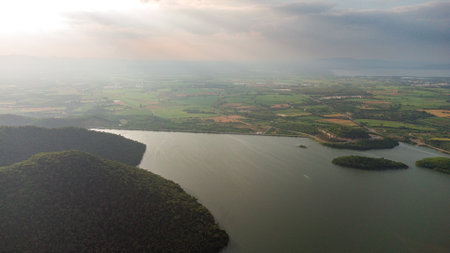 Muak Lek reservoir in Saraburi from aerial bird eye view. Beautiful unseen nature at Muak Lek dam with roadway beside with water and tree hill.の写真素材