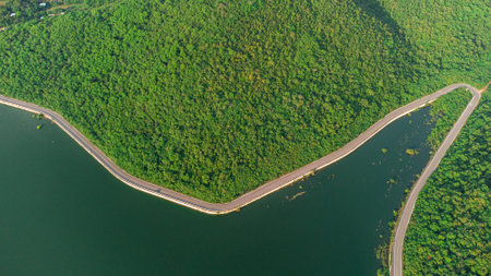 Muak Lek reservoir in Saraburi from aerial bird eye view. Beautiful unseen nature at Muak Lek dam with roadway beside with water and tree hill.の写真素材