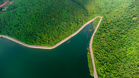Muak Lek reservoir in Saraburi from aerial bird eye view. Beautiful unseen nature at Muak Lek dam with roadway beside with water and tree hill.の写真素材