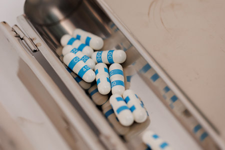 Macro Shot of colour Pills and Capsules During Production and Packing Process on Modern Pharmaceutical Factory. Tablet and Capsule Manufacturing Process. Close-up Shot of Medical Drug Production Line.の写真素材