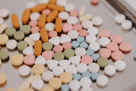 Macro Shot of colour Pills and Capsules During Production and Packing Process on Modern Pharmaceutical Factory. Tablet and Capsule Manufacturing Process. Close-up Shot of Medical Drug Production Line.の写真素材