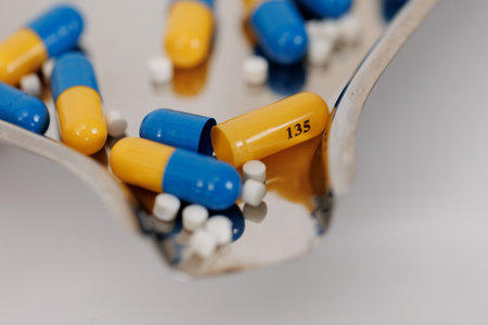 Macro Shot of colour Pills and Capsules During Production and Packing Process on Modern Pharmaceutical Factory. Tablet and Capsule Manufacturing Process. Close-up Shot of Medical Drug Production Line.の写真素材