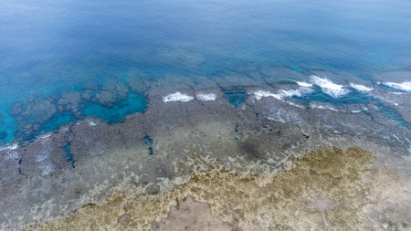 Sea surface in Okinawa with clear water and rock view by drone.の写真素材
