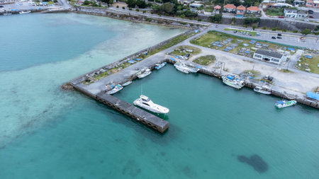 Long bridge of Kouri Island and beach from high view by drone with clear sky and sea water.の写真素材