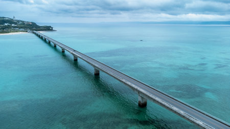 Long bridge of Kouri Island and beach from high view by drone with clear sky and sea water.の写真素材