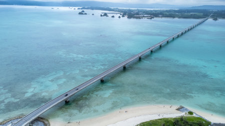 Okinawa, Japan - July 2024 : Long bridge of Kouri Island and beach from high view by drone with clear sky and sea water.の写真素材