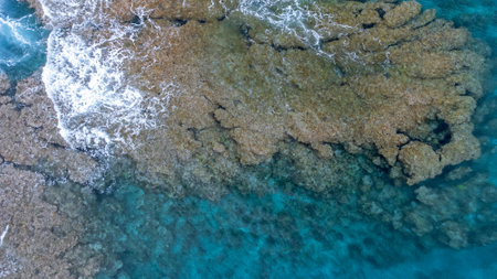 Sea surface in Okinawa with clear water and rock view by drone.の写真素材