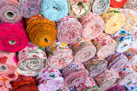 Colorful material fabric rolls texture samples. background