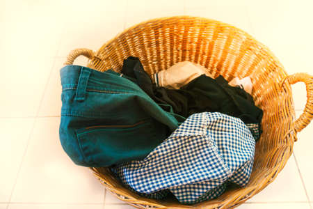 Wicker basket clothes on the floor.