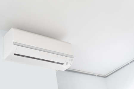 Air Conditioner in the room - Install a home air conditioner at the side walls of the ceilingの写真素材