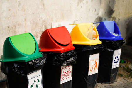 Colorful of recycle bins the old wall - Split Trashの写真素材
