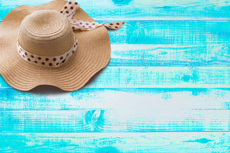 Striped retro hat flat-lay, top view, wide composition - Summer concept on wooden blue Backgroundsの写真素材