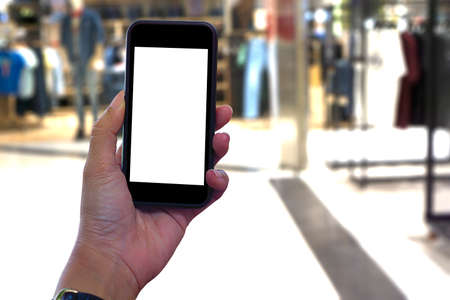 Shopping hand holding mobile empty black screen background abstract motion blurred concept, in...