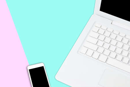 Flat lay photo of office desk with tablet and mobile on pink and green background - Knolling office...