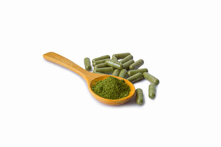 Andrographis Paniculata powder and capsules (Herbal capsules) and wooden spoon isolated on a white backgroundの写真素材