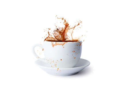 Pouring of hot coffee in cup and falling beans isolated on white backgroundの写真素材