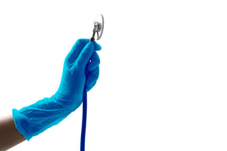 Hand holding blue medical gloves medical stethoscope side view isolated on white backgroundの写真素材