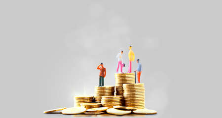 Miniature people standing businessman on top of stacks coins, small businessman figure - Concept of...