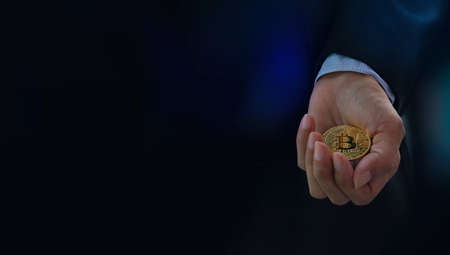 Bitcoin digital money levitates in hand business banner web on dark background - Stock Market...