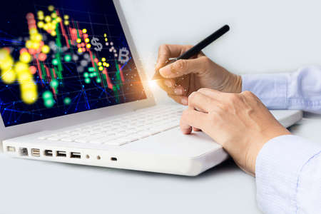 Businessman or finance analyst working in office, monitoring with trading graph marketing report on virtual screenの写真素材
