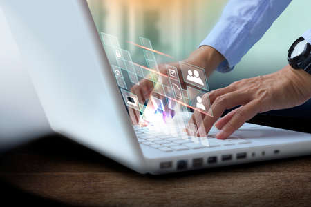 E-document, paperless office concept. Businessman working on laptop computer with electronics documentの写真素材