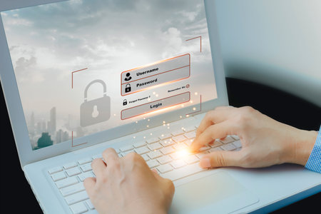 Close up of hands using laptop with login and password icon on screen. Using computer concept of...