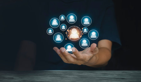 Businessman hand holding social network icon in screen. Business and technology concept. Icon Enterprise Resource Planning ERP. Technology customer support conceptの写真素材