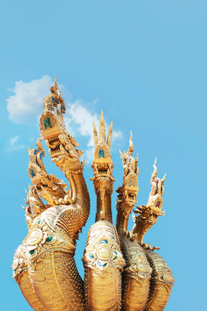 Thai-style giant statue on blue sky background, Thailand. King of Nagas, Great Naga on a blue sky. Beautiful blue naga sculpture found in the Buddhism temples.の写真素材