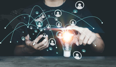 Man hand using smart phone with light bulb and social network media diagram. Internet and technology...