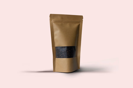 Coffee beans in a brown paper bag on a pink background. Blank brown Kraft paper bag with coffee beans in transparent window on white background.の写真素材