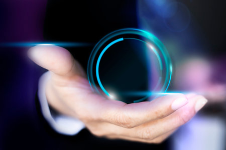 Businessman holding a virtual button with blue light in the background.の写真素材