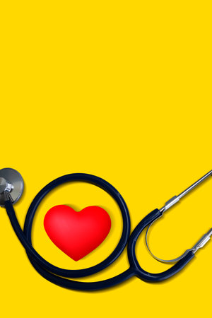 Medical stethoscope with heart health on yellow background. World mental health day conceptの写真素材