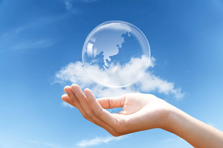 Hand holding glass globe with ESG on blue sky background for Environment Social and Governance, World sustainable environment concept.の写真素材