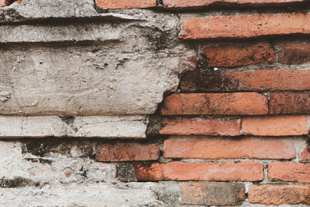 Old brick wall with peeling plaster, grunge backgroundの写真素材