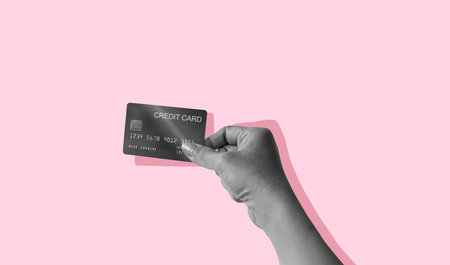 Credit card is in the antique woman's hand isolated on pink background. Art collage digital pop modern art.の写真素材