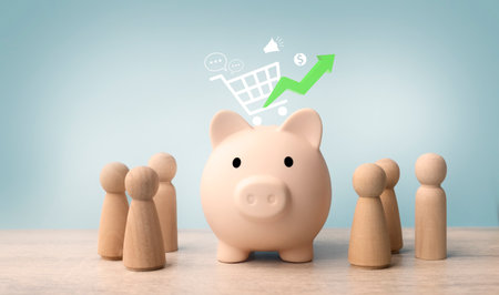 Wooden figures standing around piggy bank and shopping cart icon. Financial investment concept.の写真素材