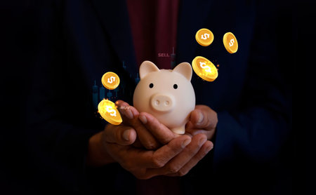 Man hand holding piggy bank, saving money wealth and financial concept.
