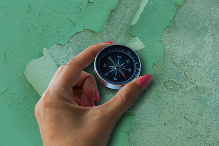 Compass in a humans hand. Business development in the right direction. Art collage