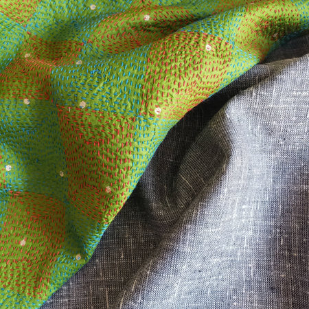 Background texture, pattern. The fabric is knitted in green and yellow.