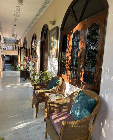 Rattan chair in front of the room door with morning sunlightの写真素材