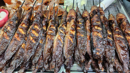 Discover a vibrant display of grilled catfish skewers, expertly cooked to perfection. This...
