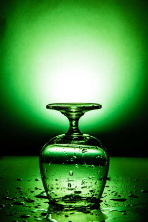 Wet wine glass with water drop, use color effect.の写真素材