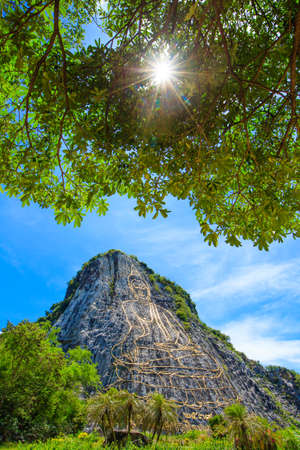 Khao chee chan the largest buddha carved in the world with trees frame and sunlight , Pattaya, Thailandの写真素材