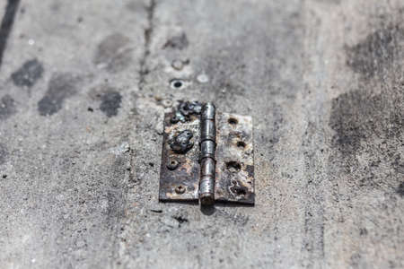 Old Steel hinge on concrete ground.