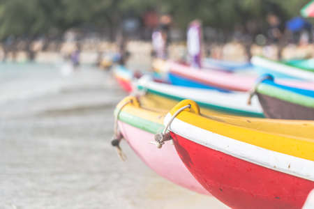 Multicolor rowboat or sea kayaks on beach with copy space. in holiday time.
