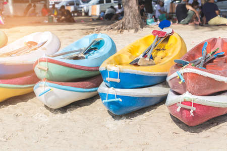 Multicolor rowboat or sea kayaks on beach with copy space. in holiday time.