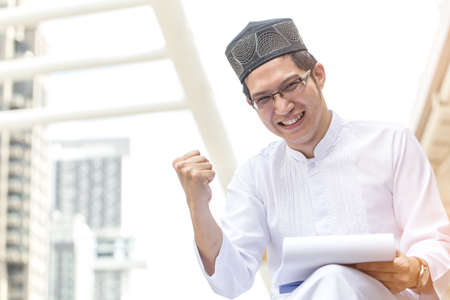 Young Handsome Confident Arab Muslims businessman expressing success, Arabian Businessman, Success Conceptの写真素材