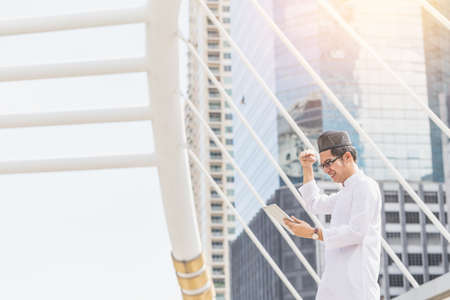 Young Handsome Confident Arab Muslims businessman expressing success, Arabian Businessman, Success Conceptの写真素材